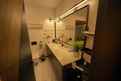 a bathroom with a sink and a large mirror at House California