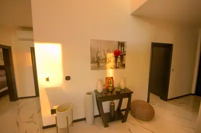 a room with a table and a picture on the wall at House California