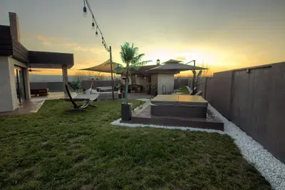 a backyard of a house with a bed in the grass at House California