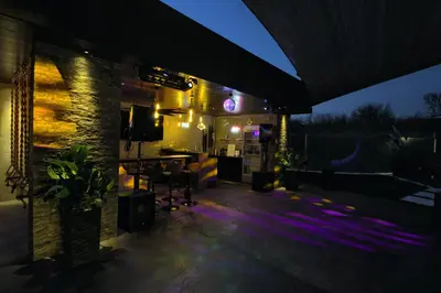 a patio at night with purple lights at House California