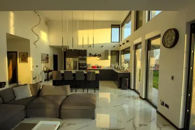 a living room and kitchen with a couch and a table at House California