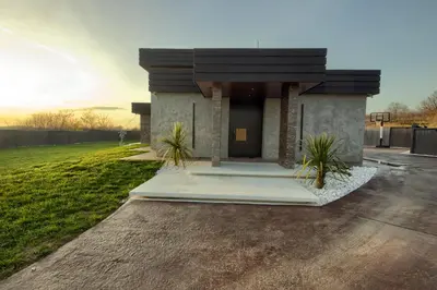 a house with a front entrance with plants in front at House California
