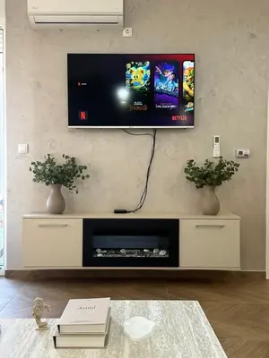 a living room with a flat screen tv on a wall at The Wolf Residence in Inđija