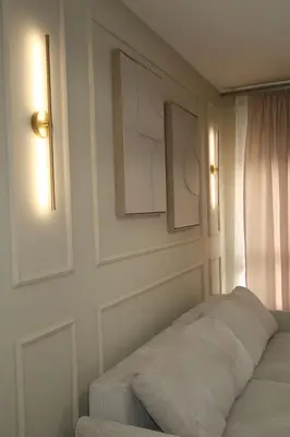 a bedroom with two pictures on the wall and a bed at The Wolf Residence in Inđija