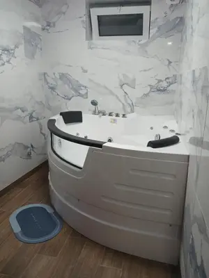 a bathroom with a white tub and a sink at Stan Na Dan Pancevo in Pančevo