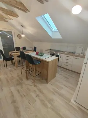 a kitchen with a table and chairs in a room at Belgrade City Home in Belgrade