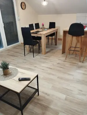 a living room with a table and chairs at Belgrade City Home in Belgrade