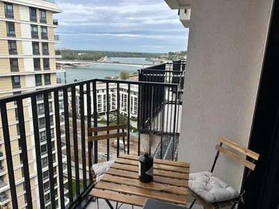 a balcony with a bench and a view of the water at NEW! Modern Studio Belgrade Waterfront in Belgrade