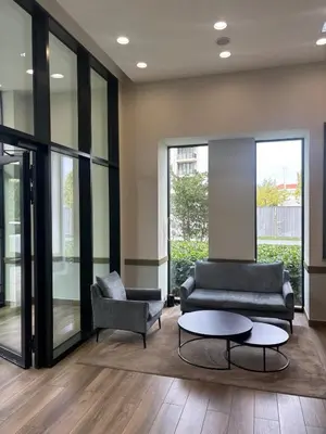 a lobby with a couch and a chair and a table at NEW! Modern Studio Belgrade Waterfront in Belgrade