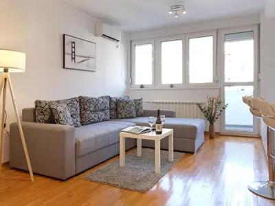 a living room with a couch and a table at Belgrade Central Residence in Belgrade