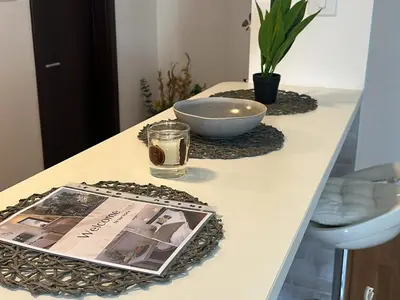 a table with a magazine and a bowl on it at Belgrade Central Residence in Belgrade