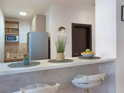 a kitchen with a counter with a bowl of fruit on it at Belgrade Central Residence in Belgrade