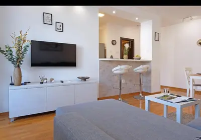 a living room with a tv on a wall at Belgrade Central Residence in Belgrade