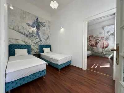 a room with two beds and a mural on the wall at Eight Apartment Two Bedroom City Centre Comfort in Belgrade
