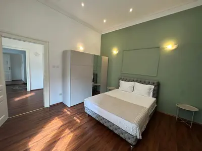a bedroom with a bed in a green wall at Eight Apartment Two Bedroom City Centre Comfort in Belgrade