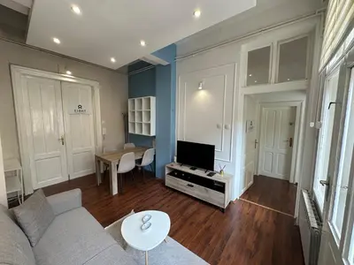a living room with a couch and a table at Eight Apartment Two Bedroom City Centre Comfort in Belgrade