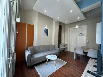 a living room with a couch and a table at Eight Apartment Two Bedroom City Centre Comfort in Belgrade