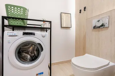 a washing machine in a bathroom with a toilet at Belgrade Nest in Belgrade