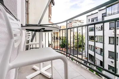 a white chair on a balcony with a view of a building at Belgrade Nest in Belgrade