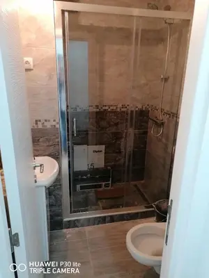 a bathroom with a shower with a toilet and a sink at City pioneer Apartmens in Belgrade