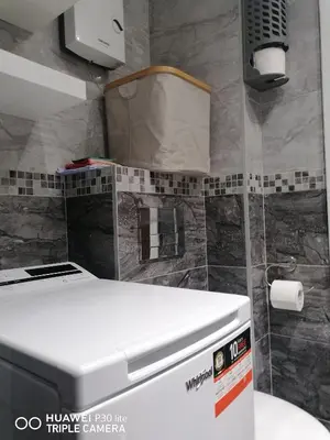 a bathroom with a toilet with a box on the wall at City pioneer Apartmens in Belgrade