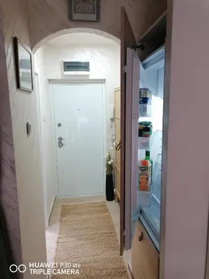 a hallway with an open door to a refrigerator at City pioneer Apartmens in Belgrade
