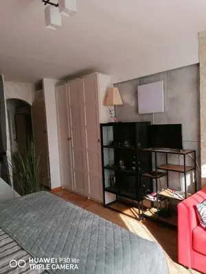 a bedroom with a bed and a book shelf at City pioneer Apartmens in Belgrade