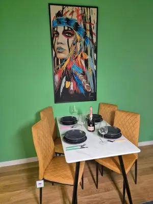 a table with chairs and a painting on the wall at 1 Bedroom Apartment Belgrade in Belgrade
