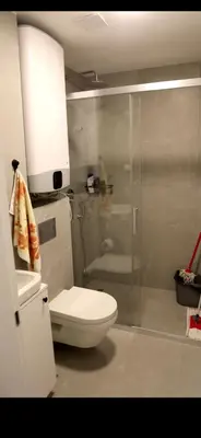 a bathroom with a toilet and a glass shower at 1 Bedroom Apartment Belgrade in Belgrade
