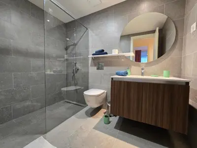 a bathroom with a toilet and a sink and a mirror at BW Eterna deluxe apartments in Belgrade