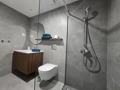 a bathroom with a shower and a toilet at BW Eterna deluxe apartments in Belgrade