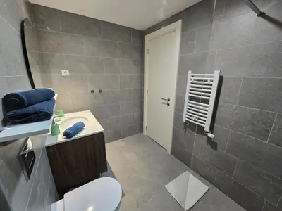 a bathroom with a toilet and a sink and a shower at BW Eterna deluxe apartments in Belgrade