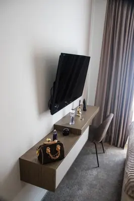 a living room with a tv on a wall at Luxurious 2BR Designer Apartment Near River & Park in Belgrade