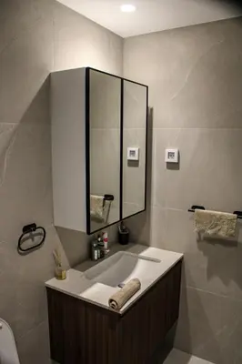 a bathroom with a sink and a mirror at Luxurious 2BR Designer Apartment Near River & Park in Belgrade