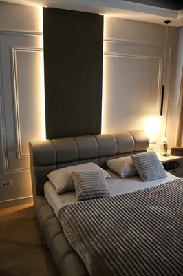 a bed with two pillows on it in a bedroom at Luxurious 2BR Designer Apartment Near River & Park in Belgrade