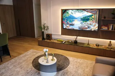 a living room with a tv and a table at Luxurious 2BR Designer Apartment Near River & Park in Belgrade