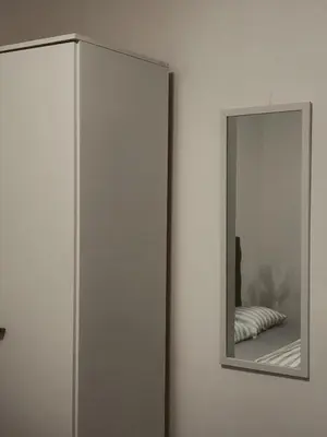 a mirror on a wall next to a bedroom at Honey apartments in Ledine
