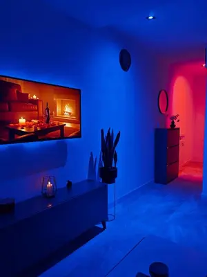 a living room with a fireplace in a blue room at Honey apartments in Ledine