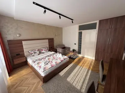 a bedroom with a bed and a desk in it at City View Apartments in Belgrade