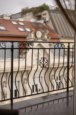 a black iron fence in front of a building at City View Apartments in Belgrade