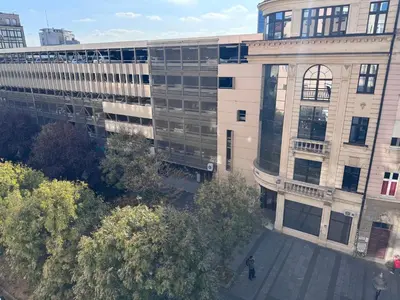 an overhead view of a building with a man standing in front at City View Apartments in Belgrade