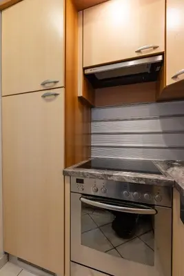 a kitchen with a stove and a refrigerator at City View Apartments in Belgrade