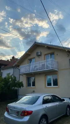 a silver car parked in front of a house at Cozy House Belgrade in Kalugjerica