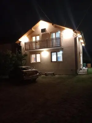 a car parked in front of a house at night at Cozy House Belgrade in Kalugjerica