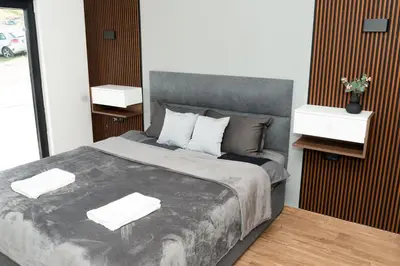 a bedroom with a large bed with two night stands at Kosmaj Sunrise in Rogača