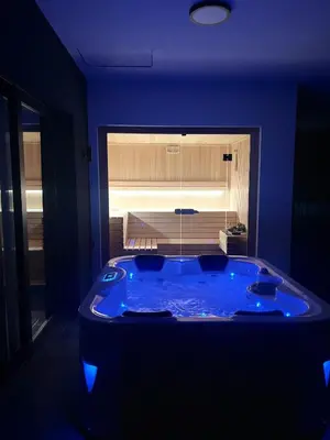 a jacuzzi tub in a room with blue lighting at Kosmaj Sunrise in Rogača