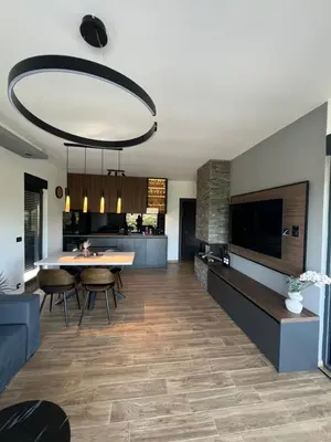 a kitchen and living room with a table and chairs at Kosmaj Sunrise in Rogača