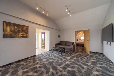 a living room with a couch and a television at Forty One Luxury Spa in Belgrade