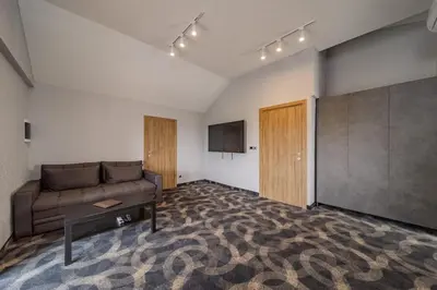 a living room with a couch and a tv at Forty One Luxury Spa in Belgrade