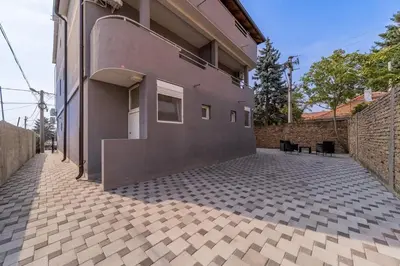 a building with a brick wall and a patio at Forty One Luxury Spa in Belgrade